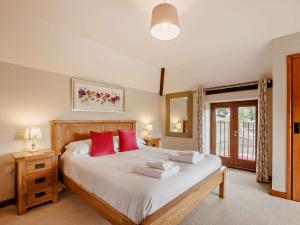 a bedroom with a large bed with red pillows at 3 Bed in Launceston BRWHI in Launceston