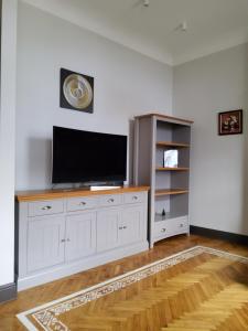 a large white entertainment center with a flat screen tv at Al Pacino apartment in Riga