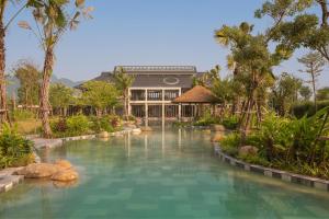 a swimming pool in front of a resort at Mandala Retreats Kim Bôi in Hòa Bình