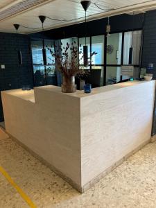 a lobby with a reception counter with a vase on it at Hedmarktoppen in Hamar