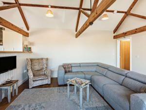 a living room with a couch and a tv at 3 bed in Barnstaple 09092 in Umberleigh Bridge