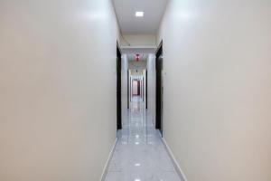 a hallway of a building with white walls and ceilings at FabExpress Swagatham Residency in Mumbai
