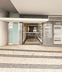 a building with a tile floor and a hallway at Anadia Atrium in Funchal