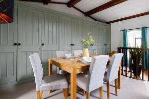 a dining room with a wooden table and chairs at Canon Gate in Chichester