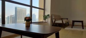a living room with a table and a large window at JBR Beach Synergy Inn in Dubai