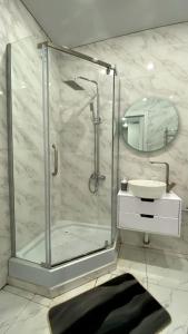 a bathroom with a shower and a sink at Евродвушка в ЖК Каратал in Kostanay +12 photos
