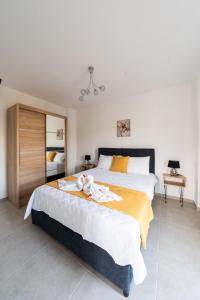 a bedroom with two beds and a chandelier at Villa Nontas Ntina with Private Pool & Playground in Rethymno Town +31 photos