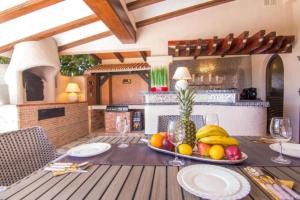 a table with a bowl of fruit on top of it at Fustera Villa El Salvador in Benissa