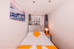 a small bedroom with a bed and a window at Superb Luxury Quality Central Apartment on Canal in Edinburgh