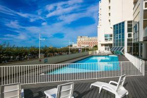 a balcony with a swimming pool and two chairs at Victoria Surf 401 - Confort & luxe Grande Plage in Biarritz