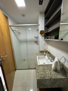 a bathroom with a sink and a shower at Luxuoso Flat Brisas do Lago Terraço Aconchegante in Brasília