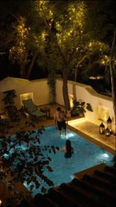two people in a swimming pool at night at Vatsalya Vihar - A Luxury Pool Villas Resort in Udaipur