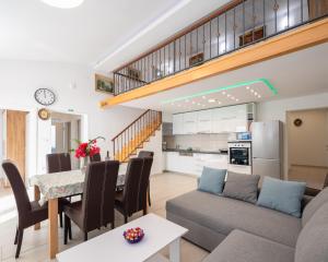 a living room with a couch and a table at Prestige Apartments in Jesenice