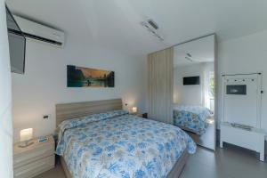 a bedroom with a bed and a large mirror at Casa Mare & Relax in Pozzuoli