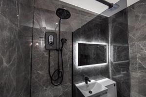 a bathroom with a shower and a sink at Stunning Bolton Abode - Cinema Experience - Parking in Bolton