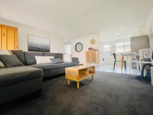 a living room with a couch and a table at Island Villas - Lady Elliott - Unit 2 in Bundaberg