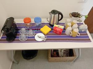 a table with utensils and dishes on it at Terra e Radici_ Betula in Spriana