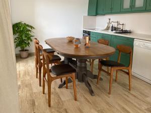 a kitchen with a wooden table and chairs at Loft with a cosy terasse in Limassol