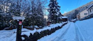 a street covered in snow with a street sign at Atelier Eliska in Staré Hory