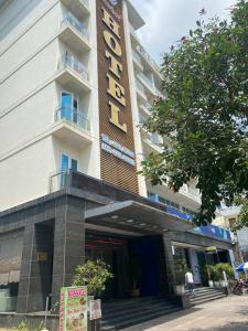 a hotel with a sign on the front of it at Central Hotel in Móng Cái