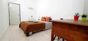 a bedroom with a bed and a dresser in it at Hostal Urban Basic in Hospitalet de Llobregat