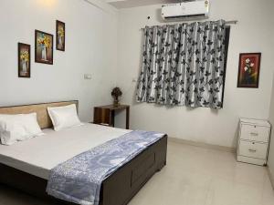 a bedroom with a large bed and a window at Leela home stay - Lotus (2 BHK luxury appartment) in Jabalpur