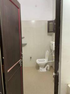an open door to a bathroom with a toilet at Leela home stay - Lotus (2 BHK luxury appartment) in Jabalpur