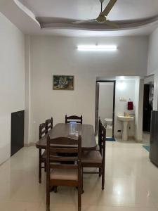a dining room with a table and chairs and a ceiling fan at Leela home stay - Lotus (2 BHK luxury appartment) in Jabalpur