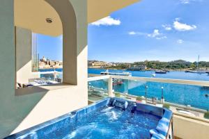 a bath tub with a view of the water at Exceptional Tigne Seafront Apartments by Shortletsmalta in Sliema