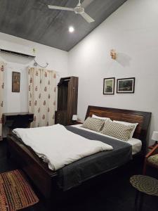a bedroom with a bed and a ceiling fan at Aambal Villa Homestay in Meenangadi +56 photos