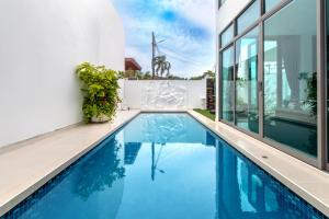 a swimming pool in the middle of a house at 【Luxury】private pool villa, perfect for vacation. Walk 700 meters to Kamala Beach 【with complete living facilities and convenient transportation】 in Kamala Beach
