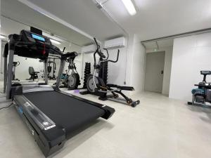 a gym with two exercise bikes and a treadmill at Apartamentos Playa Victoria in Cádiz