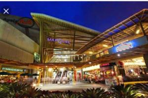 a large shopping center with a mall at night at Abl@home in Angeles