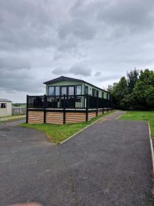 a large house with a green roof on a street at Nick's Retreat in Clitheroe