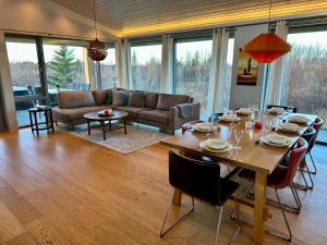 a living room with a table and a couch at Bakki in Jarðlangsstaðir