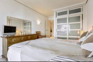 a bedroom with a large bed and a television at Balcón De Los Gigantes, Puerto de Santiago in Puerto de Santiago +19 photos