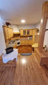 a kitchen with a bed in the middle of a room at Pension Bischof Lachtal in Lachtal