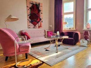 a living room with a couch and a table at Lovely Vintage Suite in Helsinki