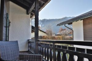 a balcony with a chair and a view of a mountain at Bergjuwel in Garmisch-Partenkirchen