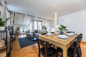 a dining room and living room with a table and chairs at Charles Apartments in Old Town in Prague