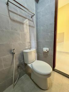 a bathroom with a toilet and a shower at Dega Gardens in Canggu