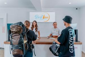 a group of people standing around a sushi counter at Surf Inn Boutique Backpackers - FREE BREAKFAST in Gold Coast