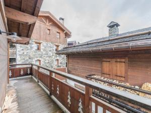 a balcony of a house with a building at Appartement La Tania, 3 pièces, 4 personnes - FR-1-568-23 in Courchevel