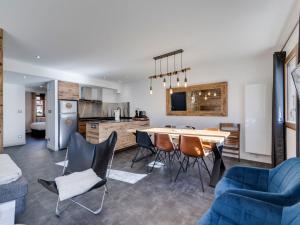 a kitchen and living room with a table and chairs at Appartement Tignes, 3 pièces, 6 personnes - FR-1-641-4 in Tignes