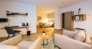 a living room with two couches and a table at Best Western Plus iO Hotel in Eschborn