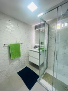 a bathroom with a glass shower and a sink at La Dolce Vita Penthouse 2 Bedroom Apartment in Arona
