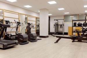 a gym with treadmills and cardio equipment in a room at Hilton Belfast in Belfast +132 photos
