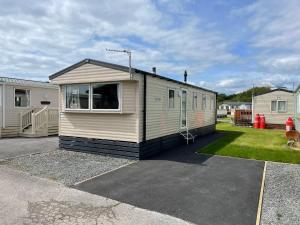 a tiny house is parked in a parking lot at Serenity - 8 Berth 3 Bedroom Static Caravan in Heysham