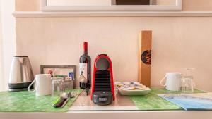 a kitchen counter with a bottle of wine and a mixer at Alla Marina Affittacamere in Riomaggiore