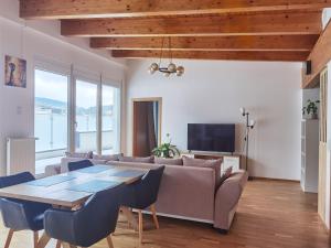 a living room with a couch and a table at BeeHome Apartment in Purkersdorf